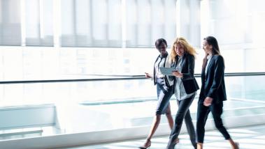 Three women in business walking together.
